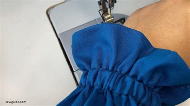 How do you hand sew elastic to gather fabric?
