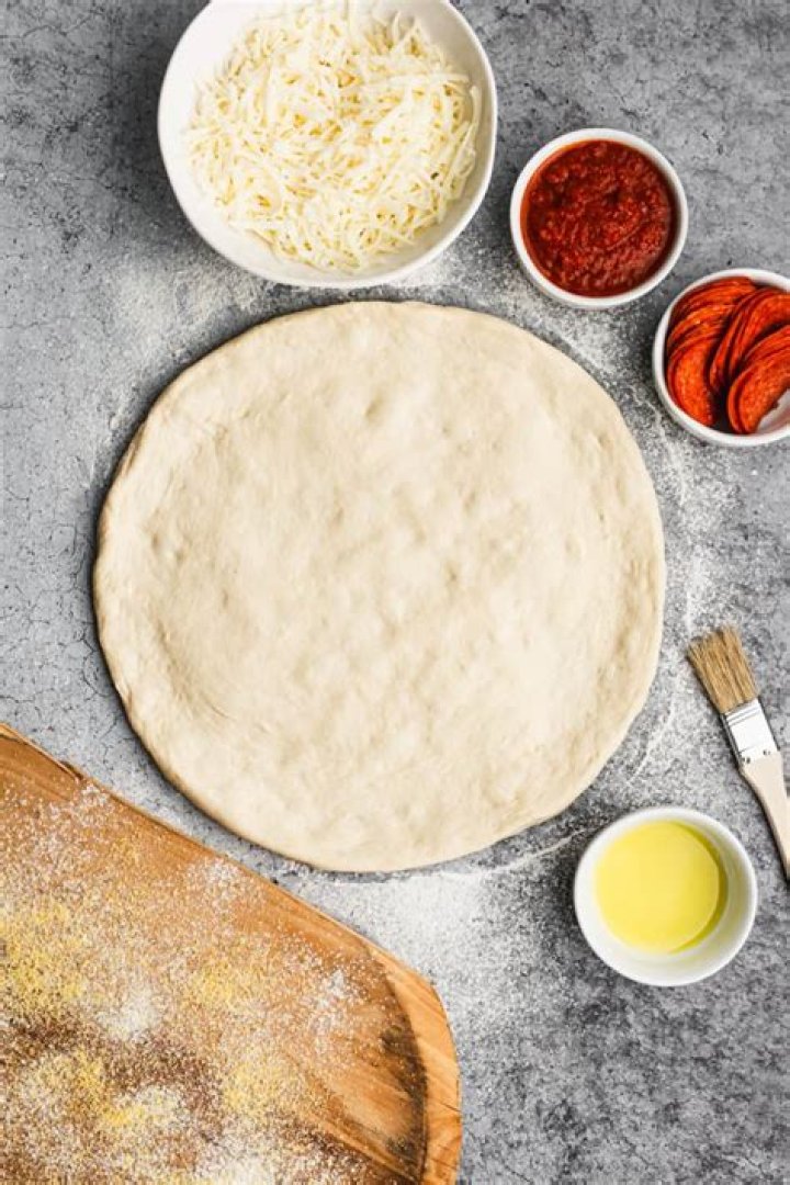 What does adding olive oil to pizza dough do?