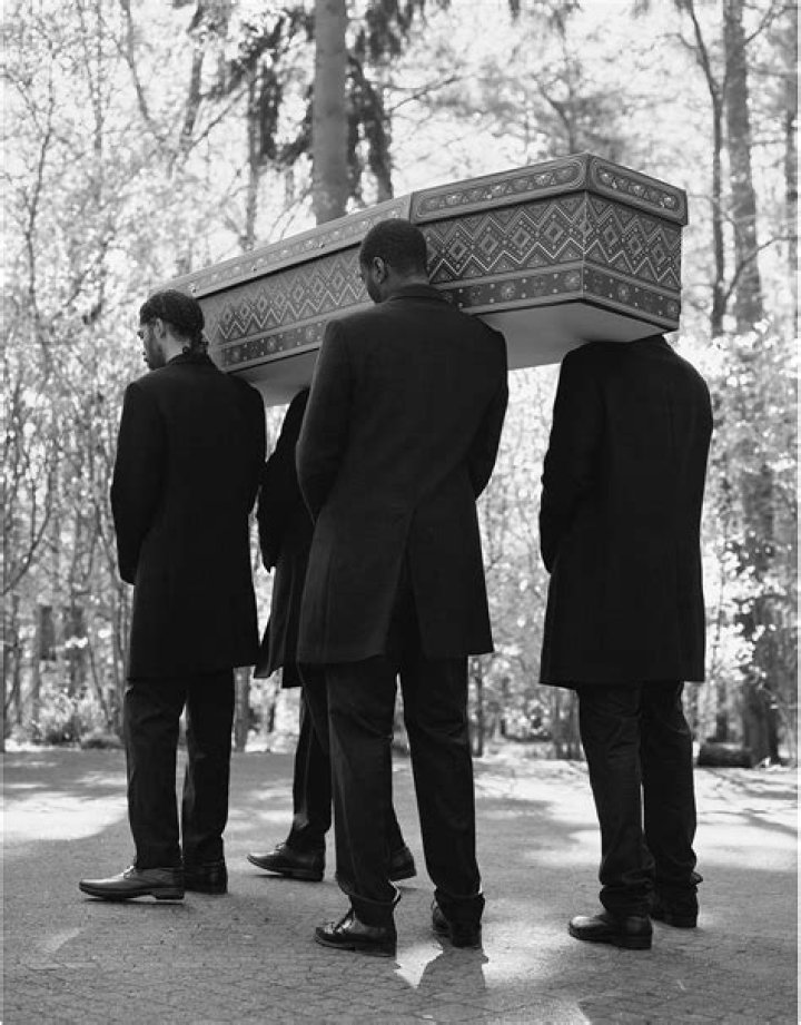 Who are the black guys carrying a coffin?