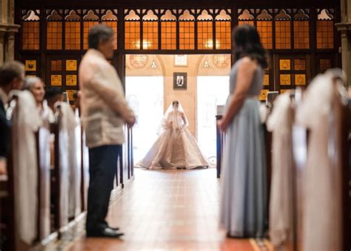 Who walks the bride down the aisle if she has no family?