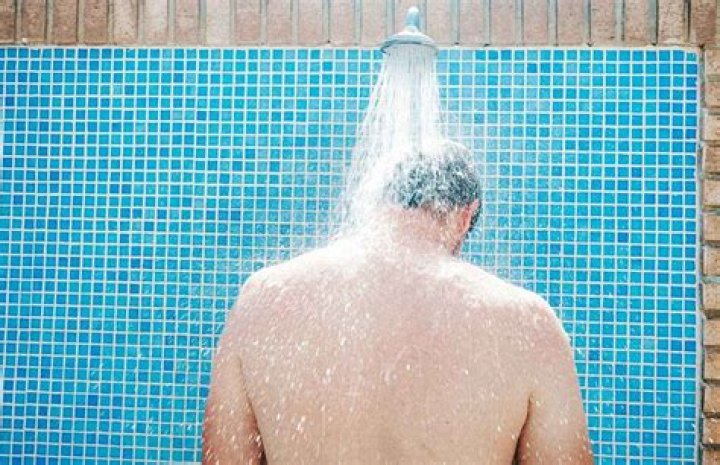 Why do swimmers shower before swimming?